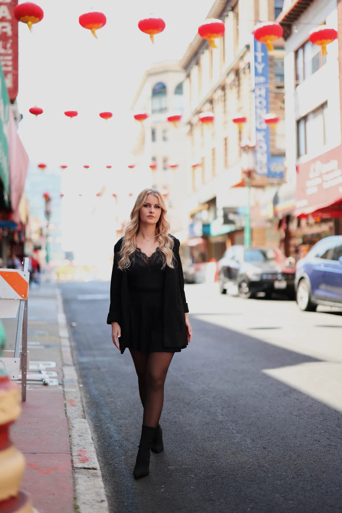 Anna in front of colorful vendor stalls in Chinatown, San Francisco 1 of 12
