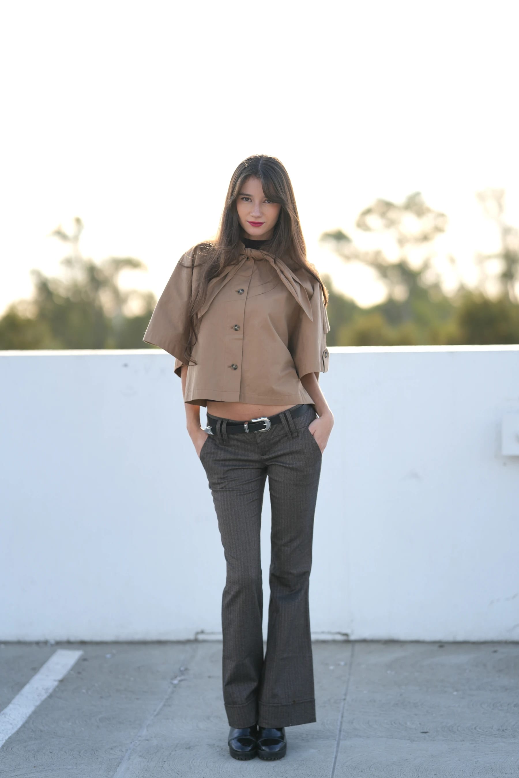 Rosina full length against a white rooftop wall — photo A