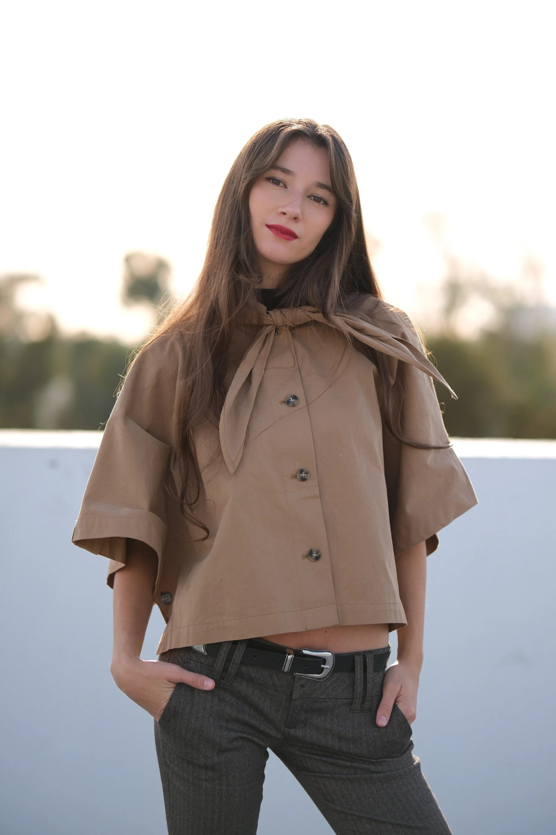 Rosina half body on a rooftop with her hands in her pockets — photo A
