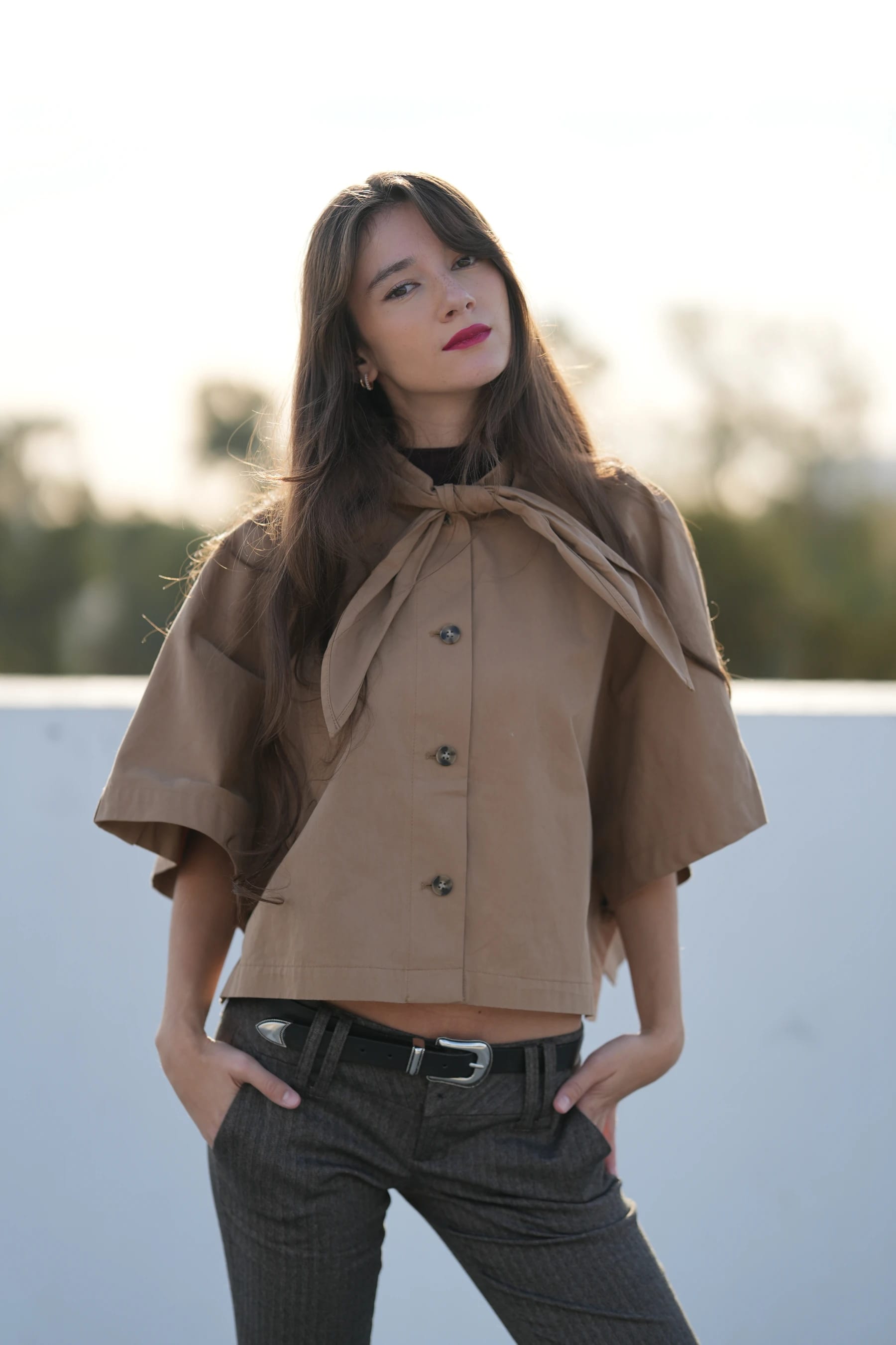 Rosina half body on a rooftop with her hands in her pockets — photo B