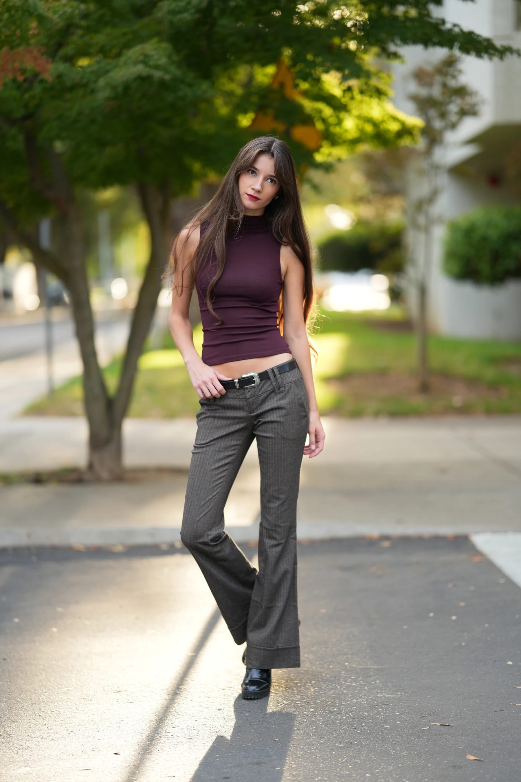Rosina full length on a tree-lined sidewalk in a plum top — photo B