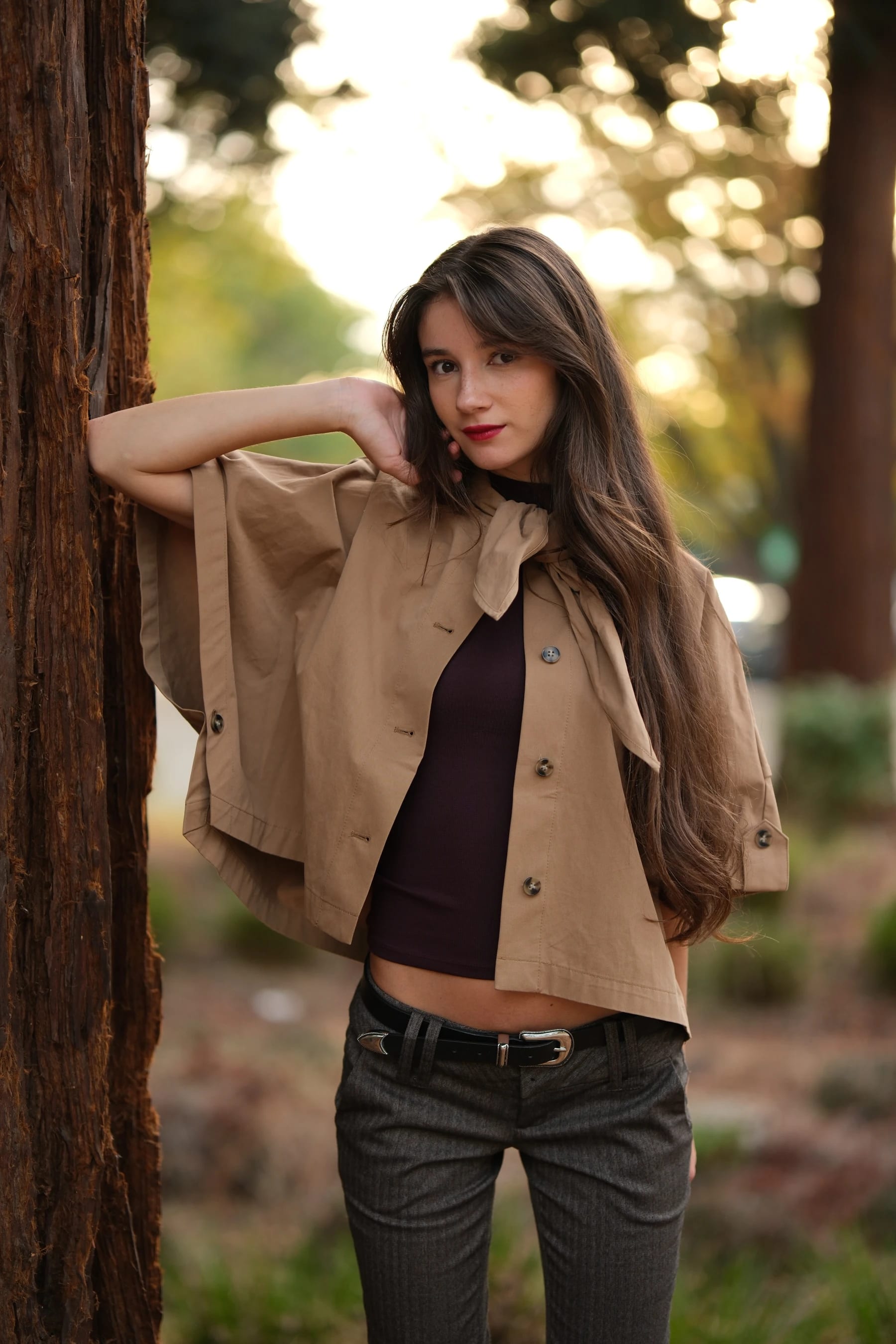 Rosina by a redwood with one hand behind her head — photo B
