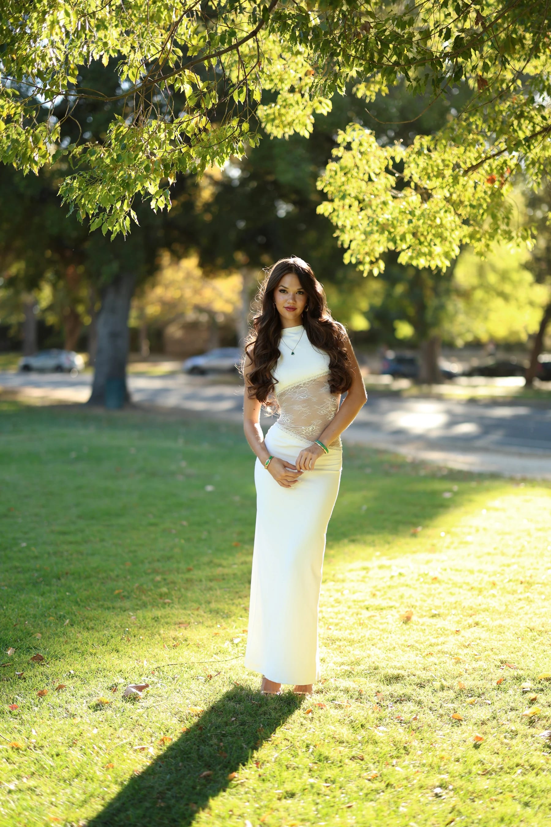 Mia full length on a sunny lawn in William Land Park — photo A