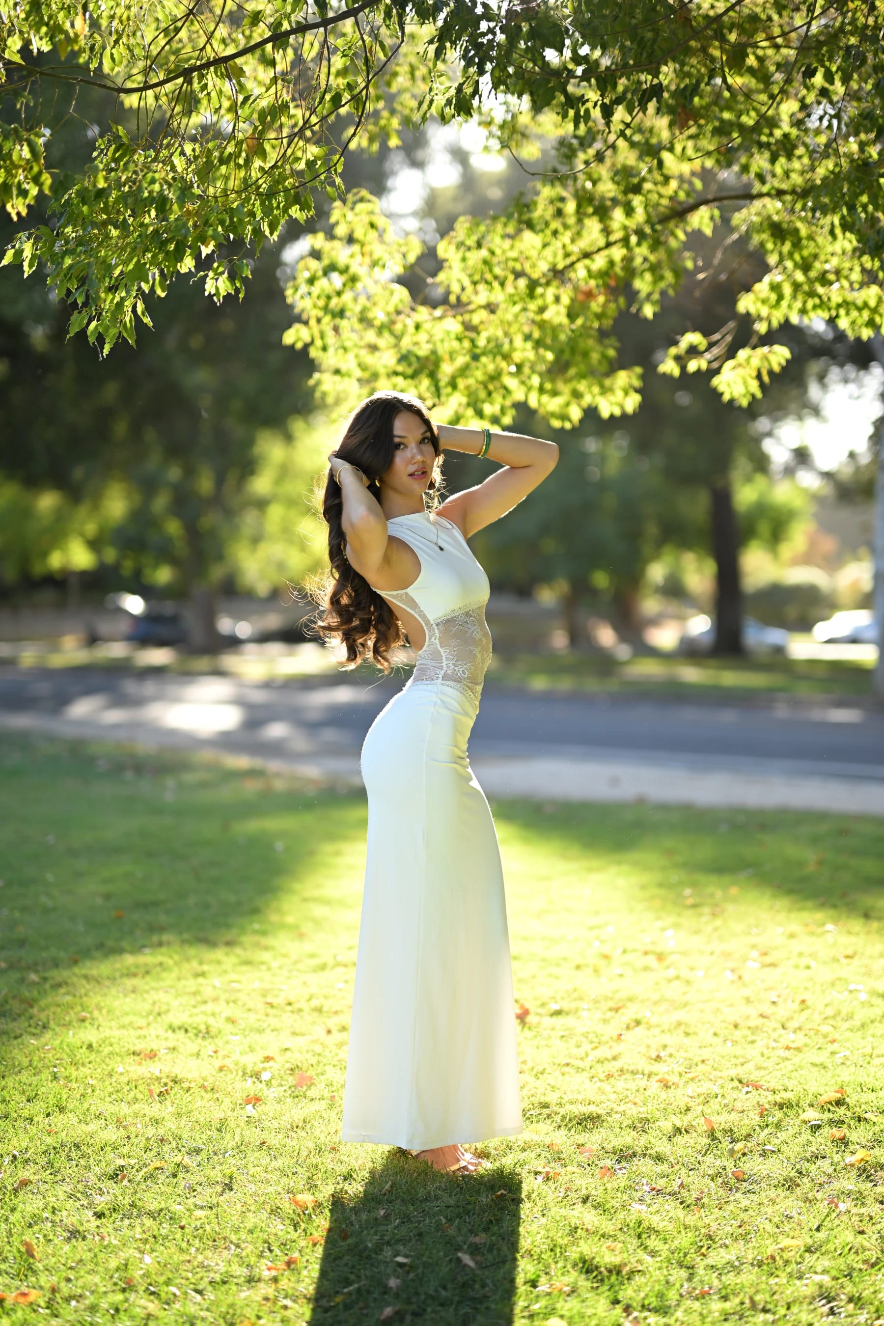 Mia full length, backlit with arms raised and her shadow toward the camera — photo B