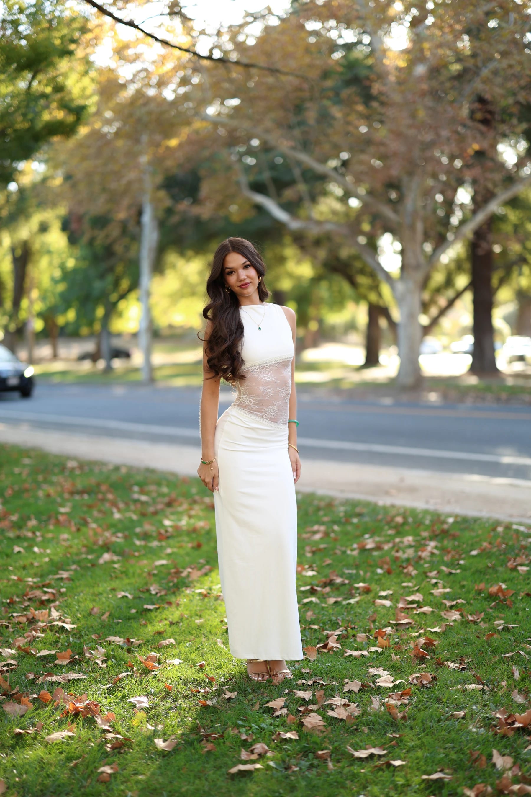 Mia full length in open shade on a lawn by the road — photo B