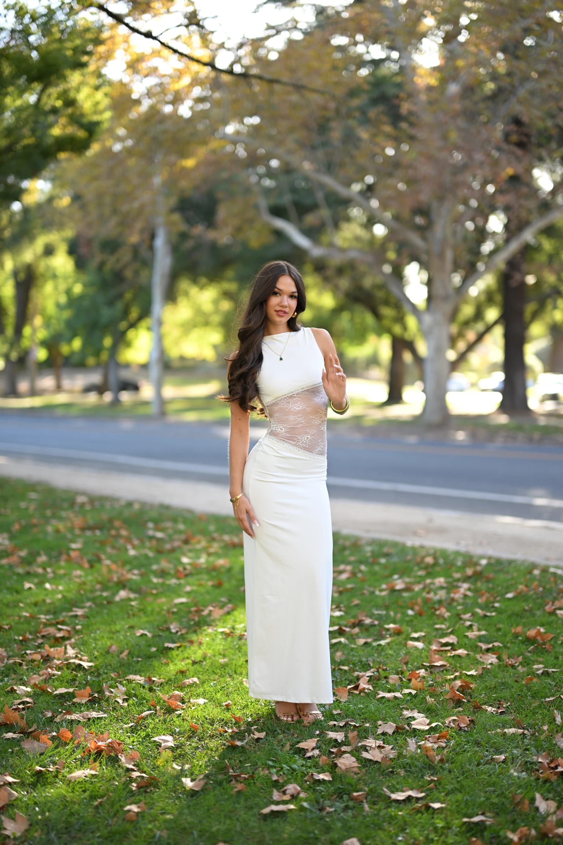 Mia full length in open shade on a lawn by the road — photo A