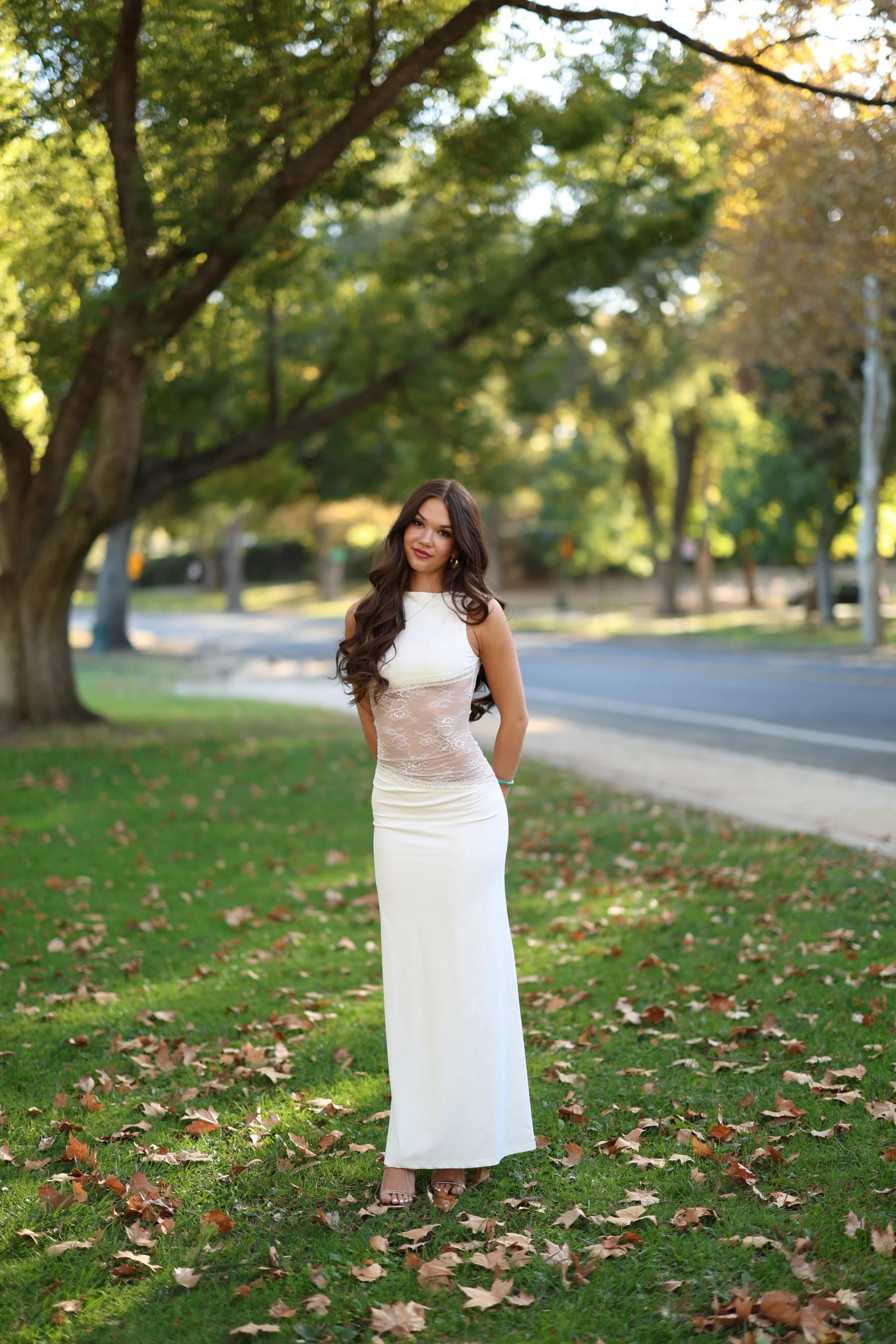 Mia full length under big oak trees — photo B