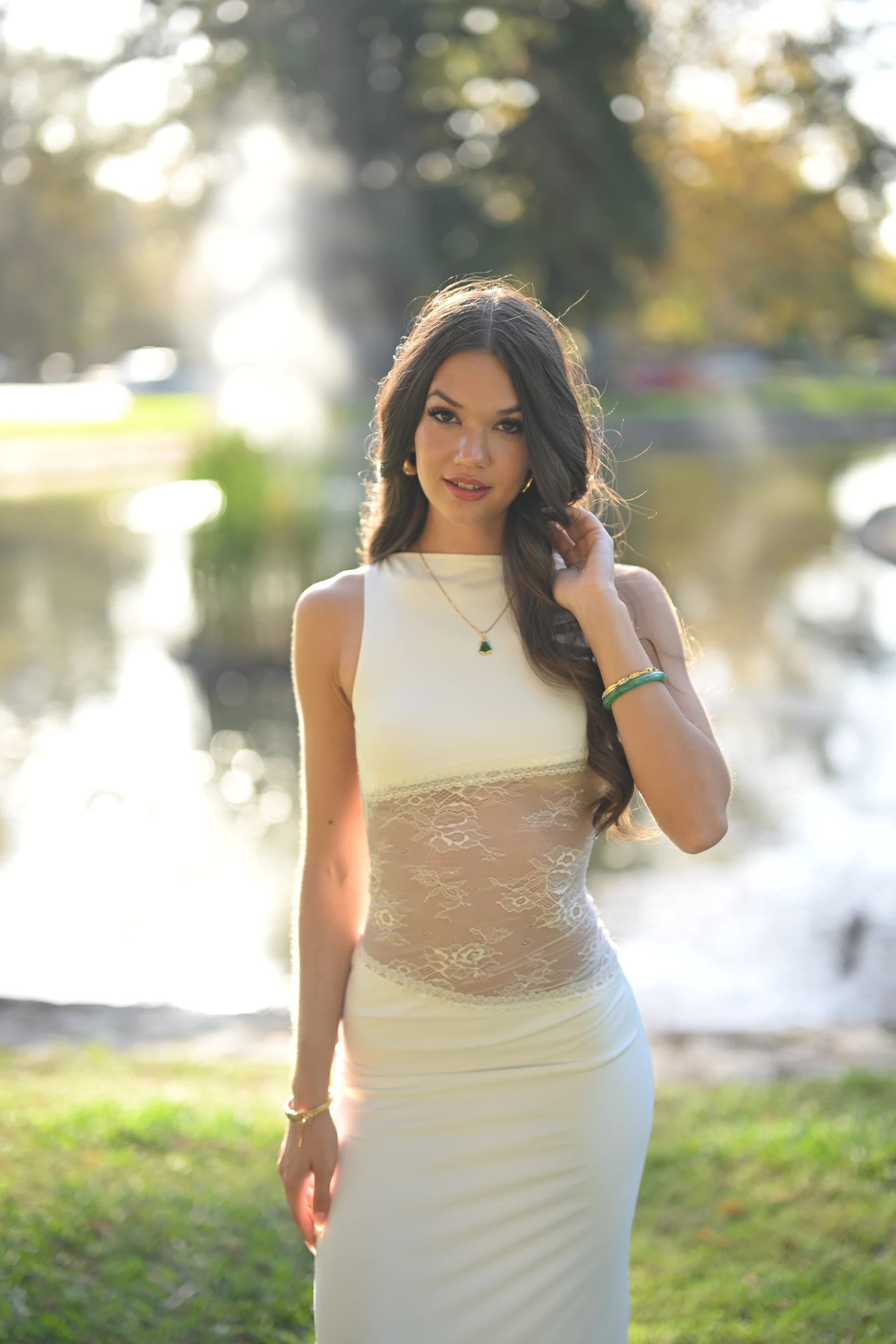 Mia half body in front of the backlit fountain — photo B