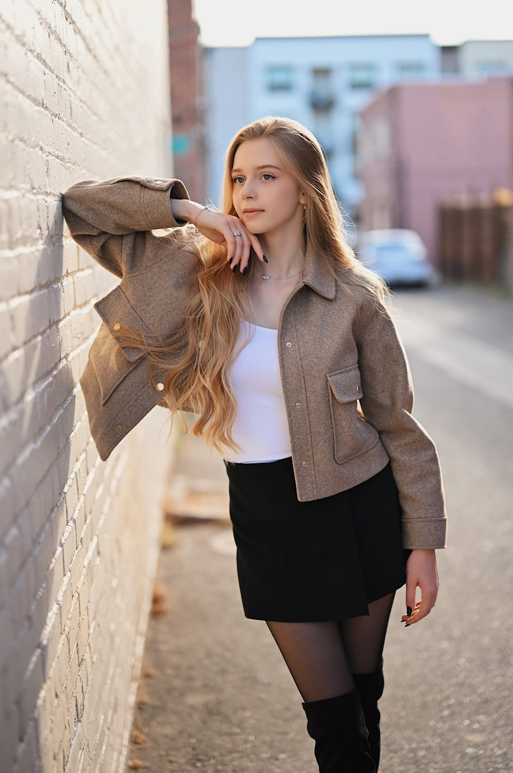 Sofia backlit portraits against a white wall 1 of 3