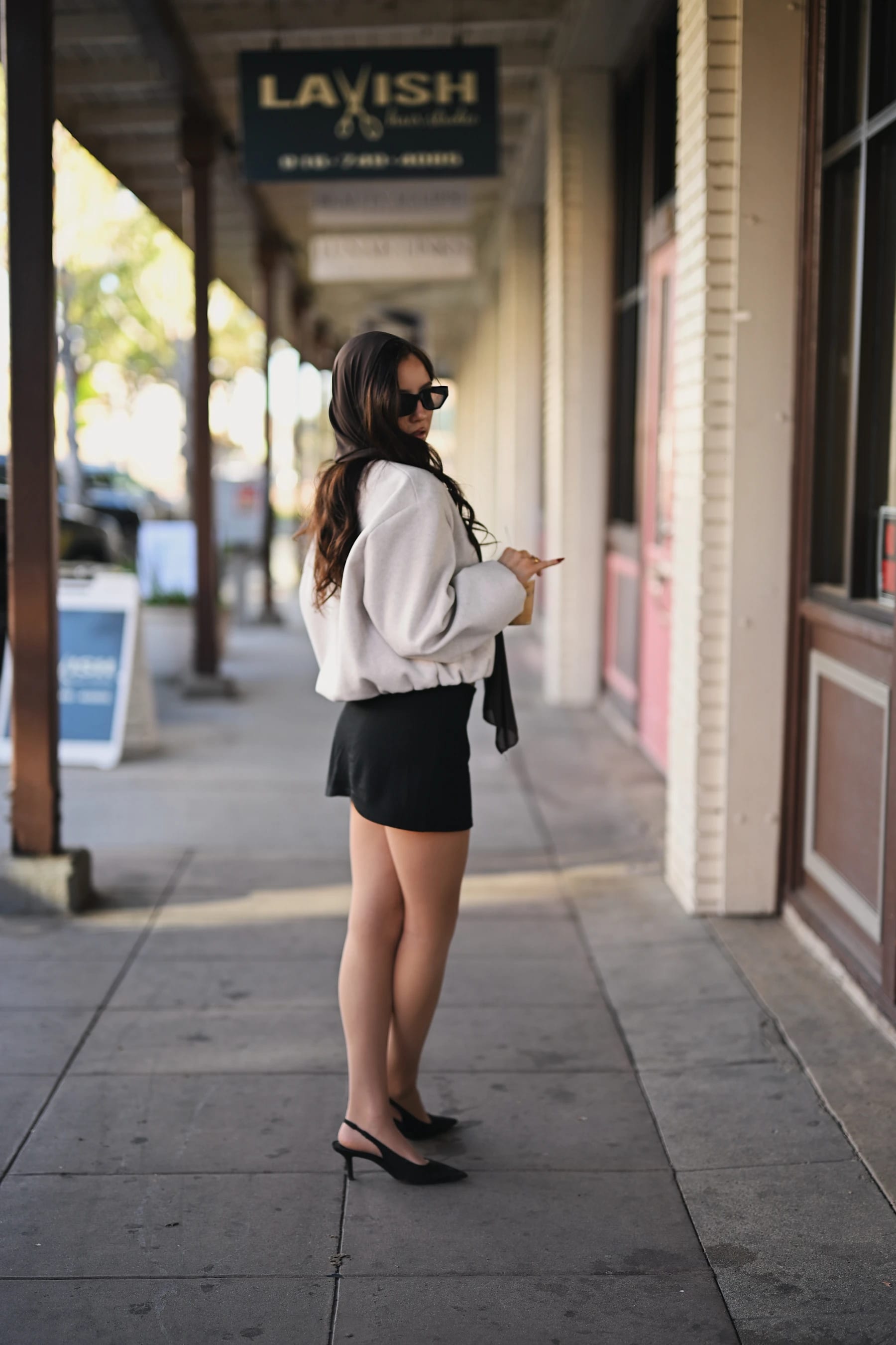 Yasmina sidewalk framing portraits under a covered arcade in downtown Roseville, Nikon Z6III Nikkor Z 50mm f/1.2 S 1 of 11
