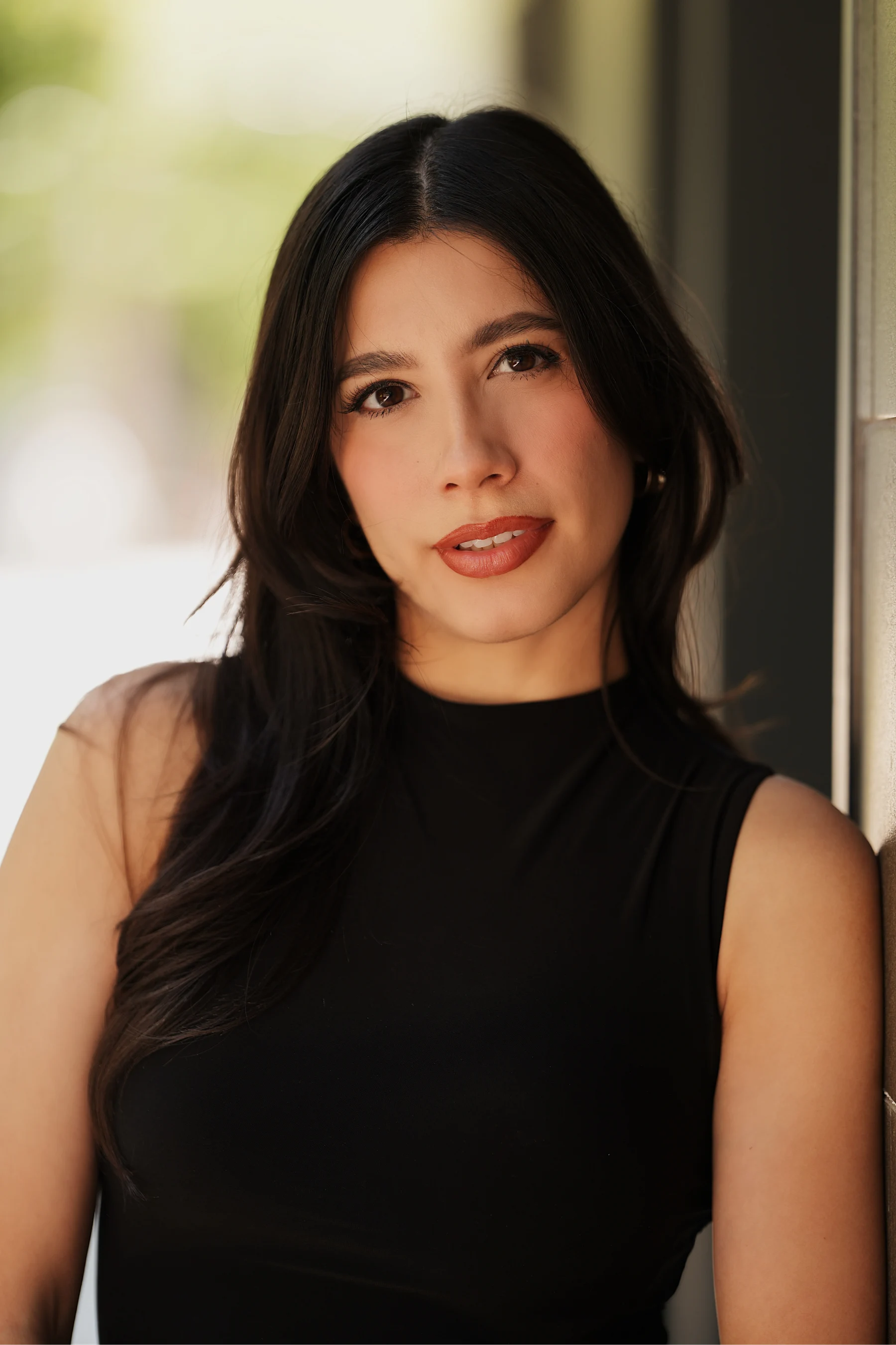 Aranza in a black dress and boots, downtown breezeway street portraits 1 of 10