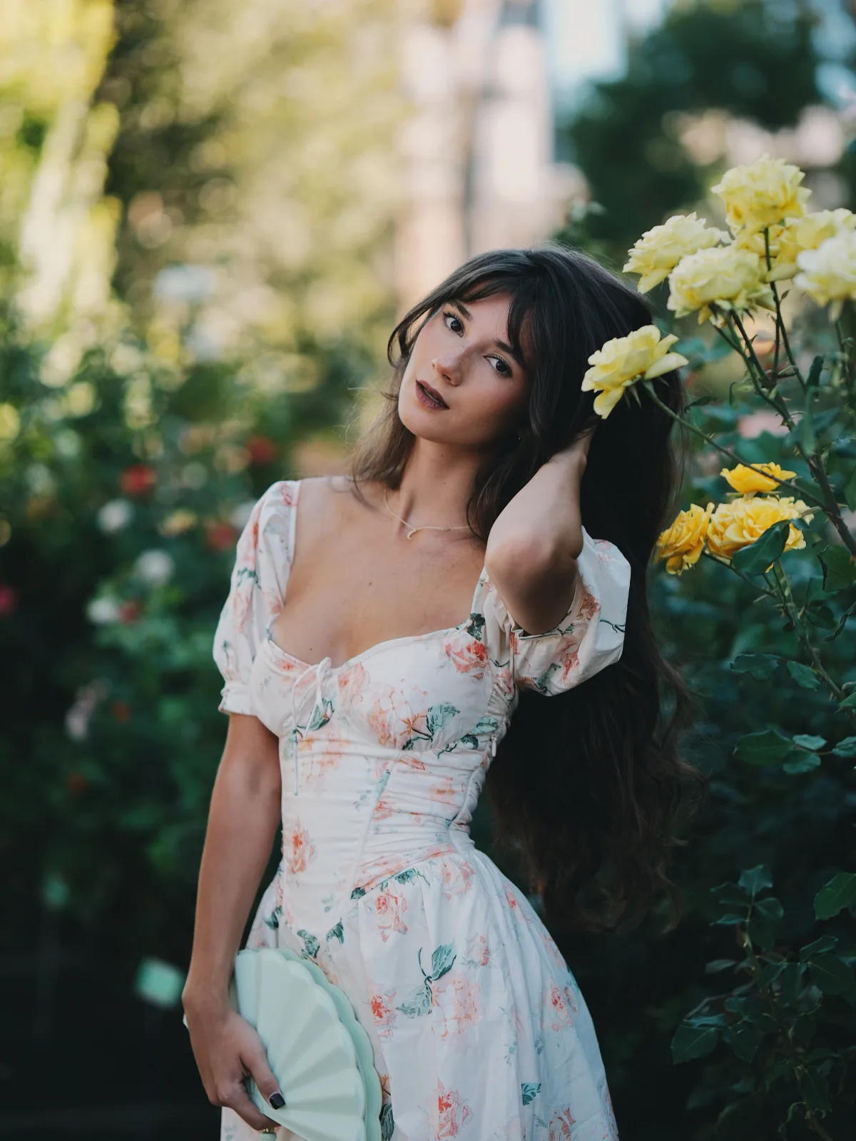 Rosina in the rose garden with yellow and pink roses